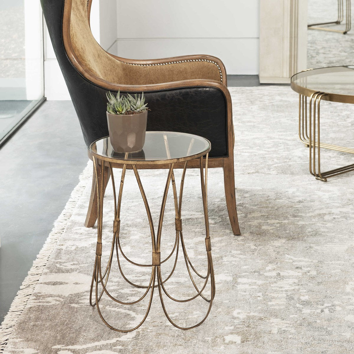 Uttermost Kalindra Glass Top With Antiqued Gold Iron Modern Round Accent Table - Image 1