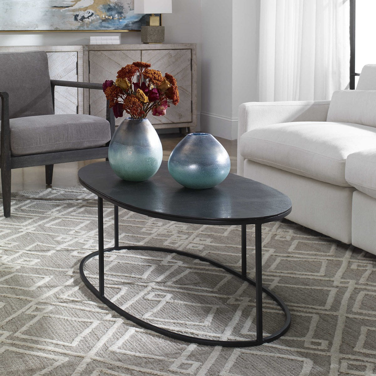 Uttermost Coreene Antiqued Black With Aged Black Iron Modern Oval Coffee Table - Image 1