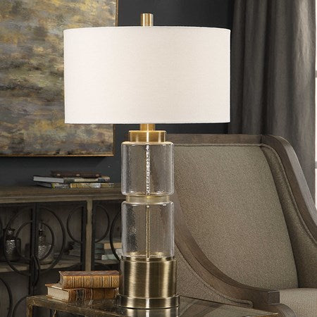 Uttermost Vaiga Antique Brass and Clear Glass Table Lamp With White Linen Shade - Image 1