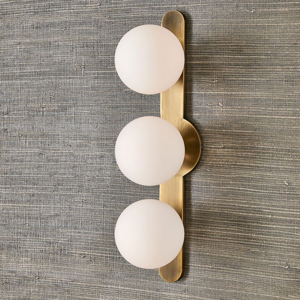 Uttermost Droplet Matte White Opal Globes With Antique Brass Finish 3 Light Sconce - Image 1